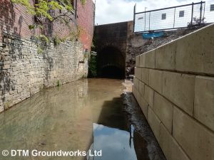 Concrete block river retaining wall - DTM Groundworks Ltd